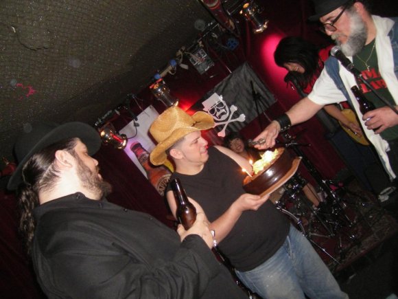 BIG RON watches as TRISTAN holds the cakes and Mr. WOOD lites it up!