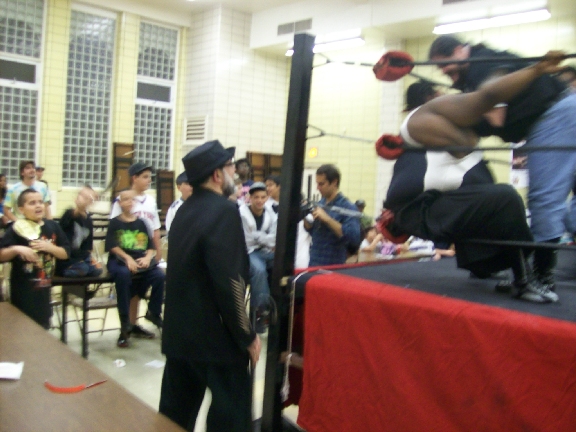 BIG RON gives LUCIFER a beat down in the corner.