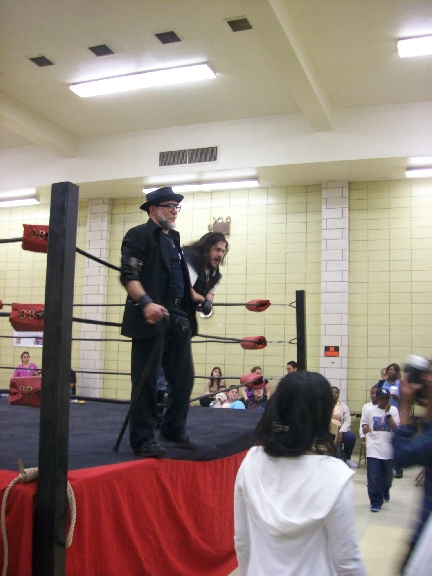 BIG RON & Mr. WOOD watch as LUCIFER steals off with the belt!