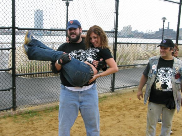 BIG RON lifting EILEEN while CRAZY GLENN watches.
