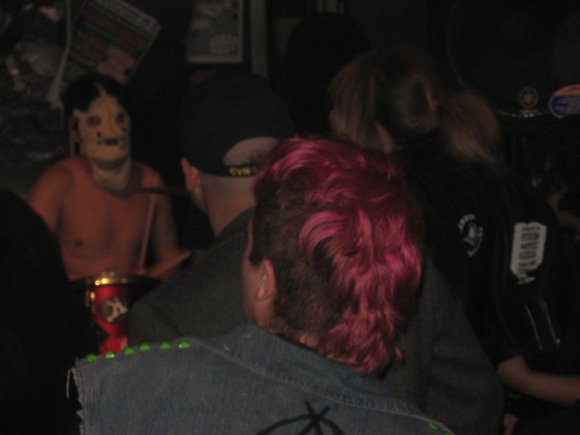 That's the BLACKOUT SHOPPER's drummer behind the mask in the back.