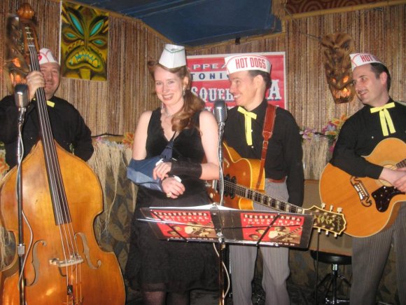 NELL joins the boys on stage for a photo op with the "Hot Dog" hats.