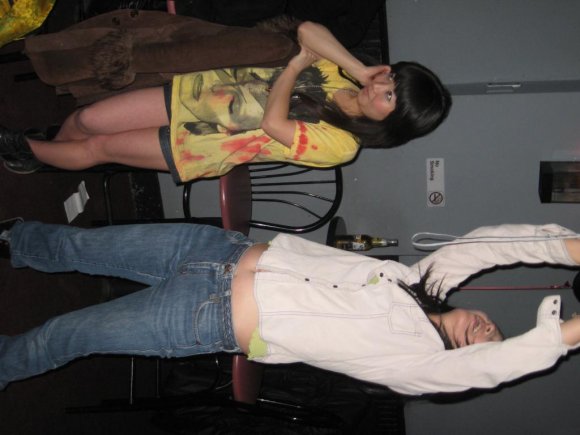 HITOMI watches RLKM as YUKA takes a picture.