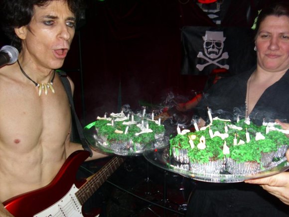 BOBBY blows out the candles.