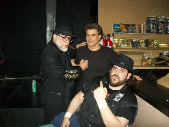 Mr. WOOD and BIG RON joined at the merch table by GEORGE CRISIS.