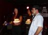 PURPLE PAM sings HAPPY BIRTHDAY as BABS and Mr. WOOD stand by, stunned.