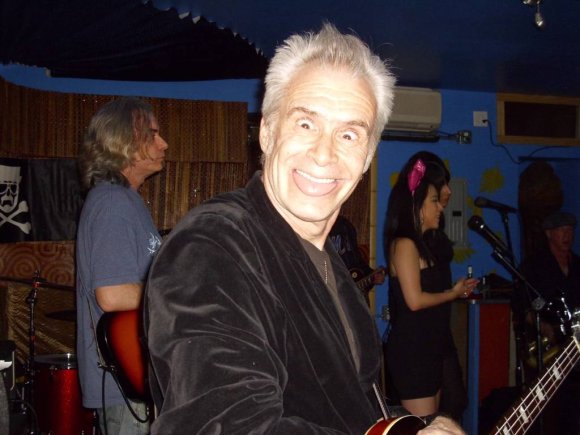 KEVIN poses with T. J. and STELLA in the background.