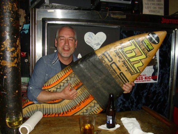 HANK's owner JOHN grabs a surf board.
