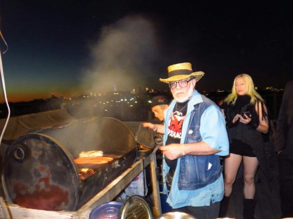 Mr. WOOD arranges the grill as CRAZY GLENN preps something and ANTOINETTE watches!