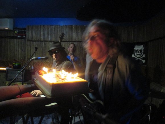 JOHNNY and CALVIN watch as T. J. blows out his candles!