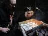 ROB watches as TERESA blows out the candles!